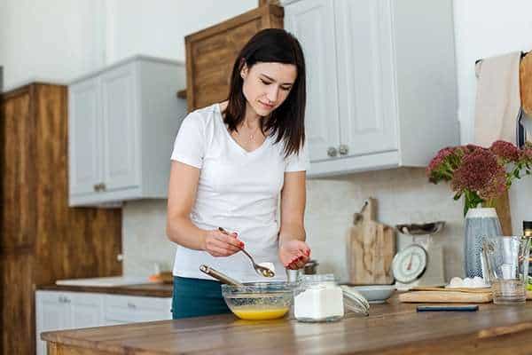 About us Person preparing ingredients in a kitchen during an Active Therapy Services occupational therapy session in Adelaide.